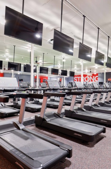 Rows of treadmills inside VASA Fitness