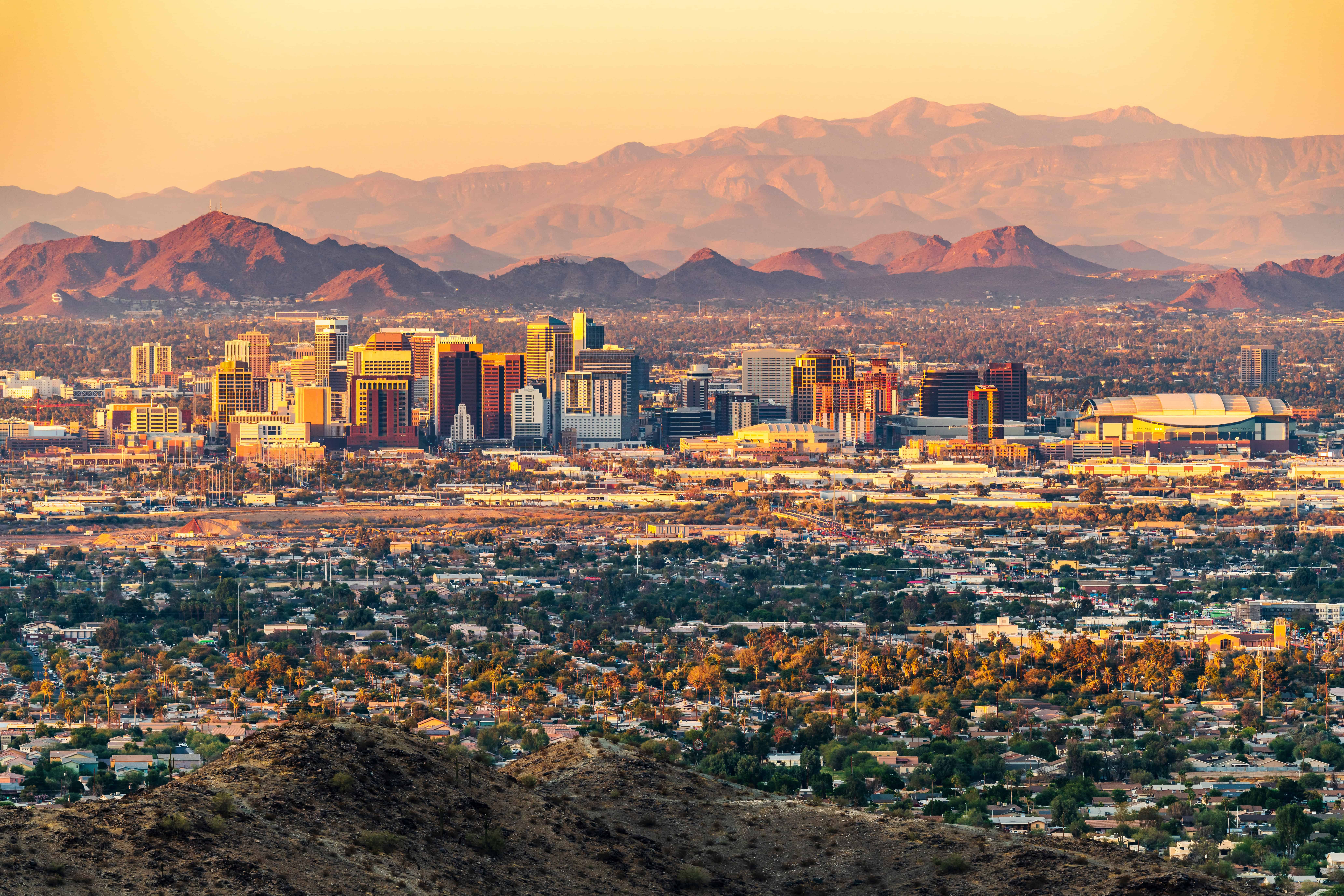 Skyline view of Phoenix on a cliff during dawn with pretty purple mountains in the background